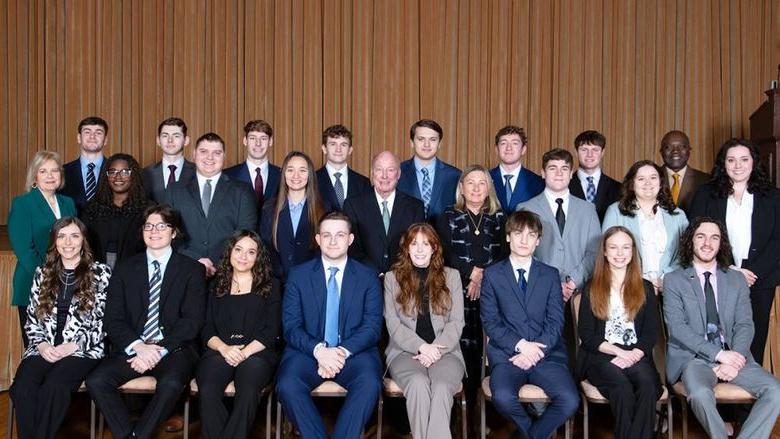 A group of students, faculty, staff and donors posing for a photo at the induction of the 14th class of Sheetz Fellows