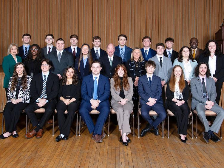 A group of students, faculty, staff and donors posing for a photo at the induction of the 14th class of Sheetz Fellows